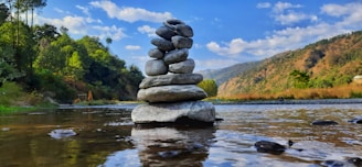 gray and black stone on water during daytime