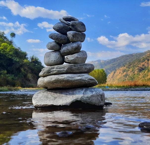 gray and black stone on water during daytime