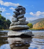 gray and black stone on water during daytime