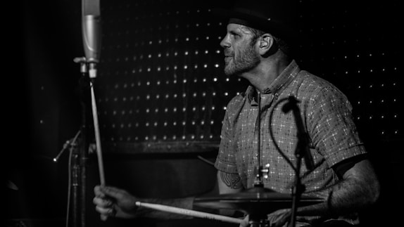 A drummer wearing a leather drum accessory from Killner Retro during a live performance.