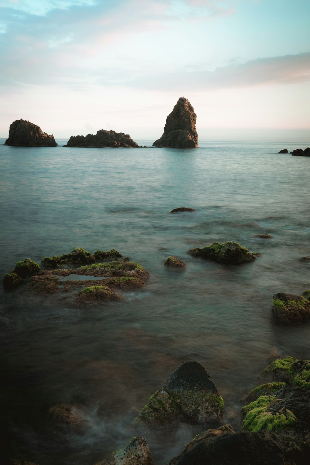 brown rock formation on sea during daytime