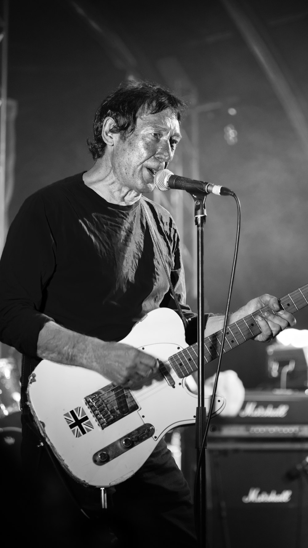 man in black long sleeve shirt playing guitar