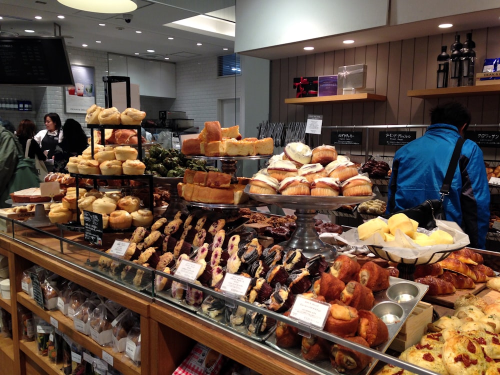 assorted breads on brown wooden shelf