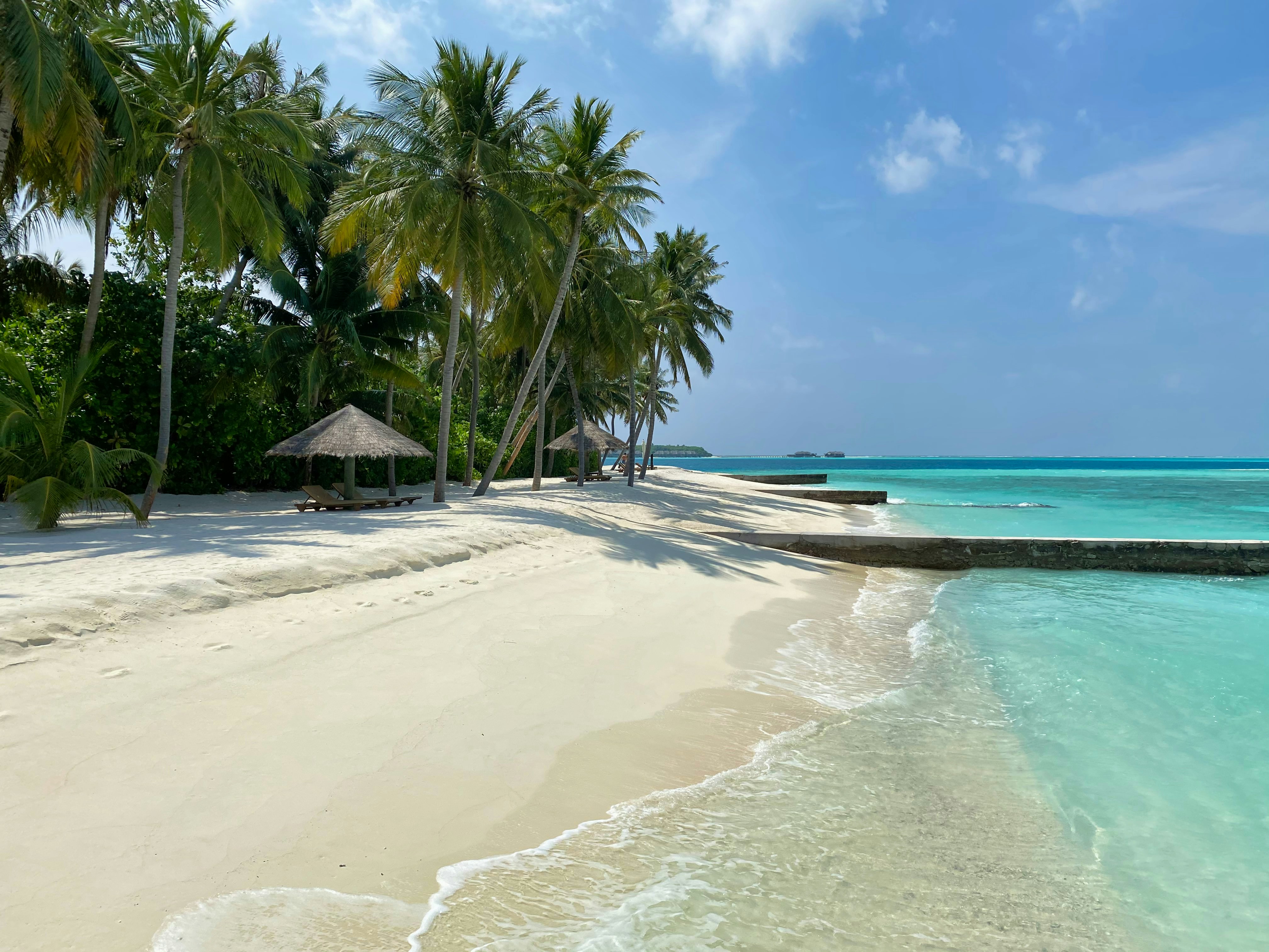 Standing on the smooth sandy beach of Alif Alif in Maldives.