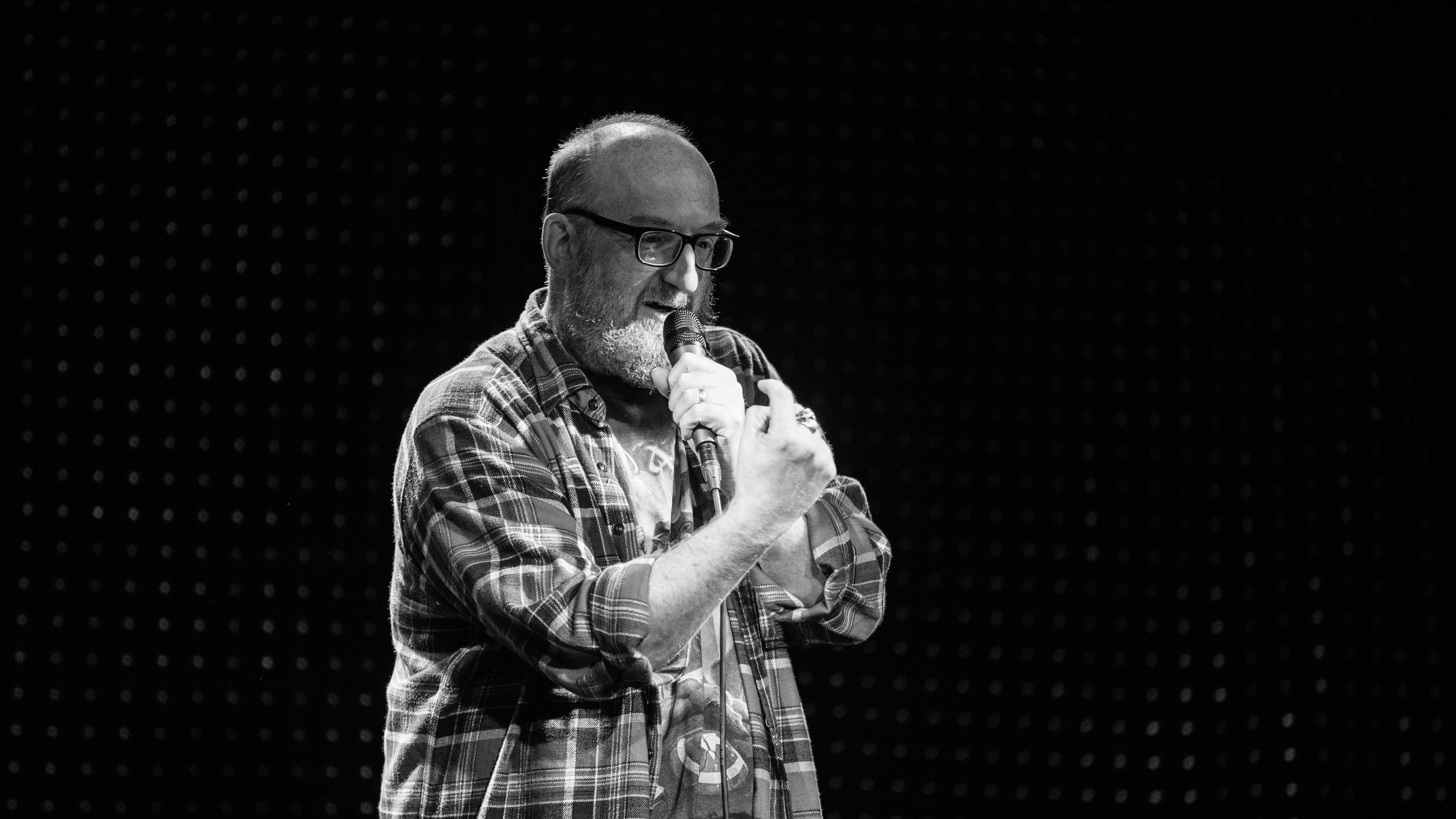 man-in-plaid-button-up-shirt-drinking-from-bottle-photo-free-grey