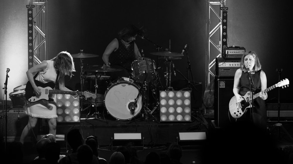 grayscale photo of man playing drum