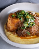A hearty meatloaf with mashed potatoes and gravy.