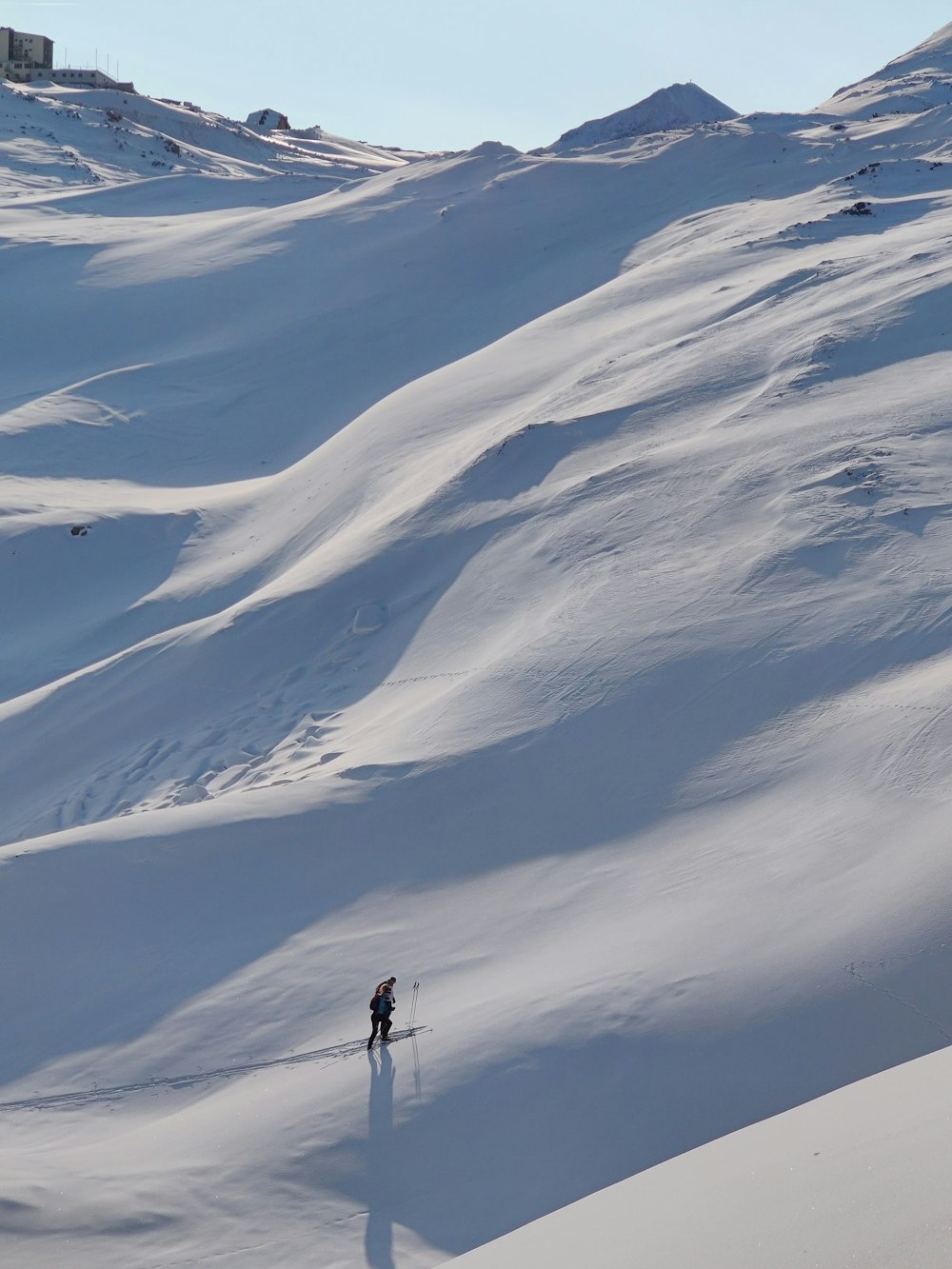 person standing on snow covered mountain during daytime