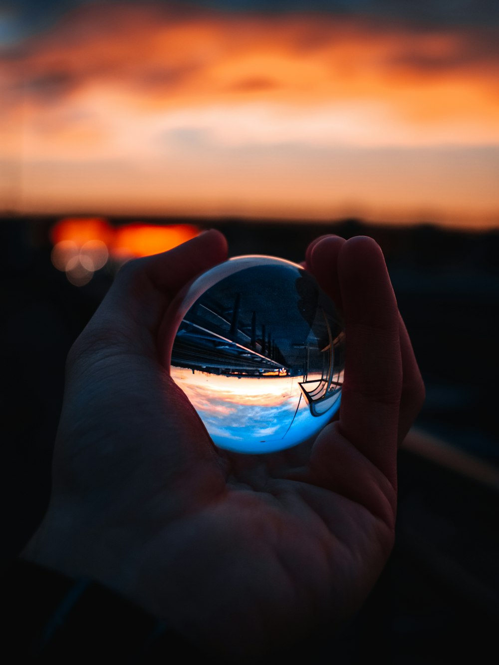 person holding clear glass ball