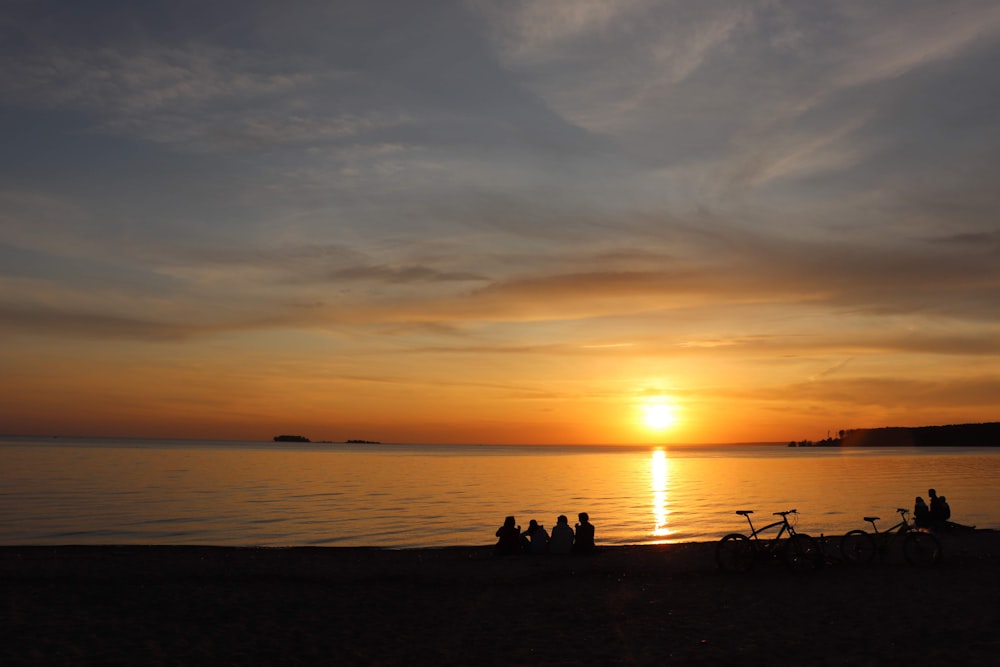 silhouette of people riding horse during sunset