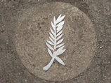 Close-up of the laurel wreath symbolizing success and recognition.