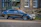 Luxury sedan with a glossy finish parked outside a modern home, freshly detailed by Obsidian Car Care.
