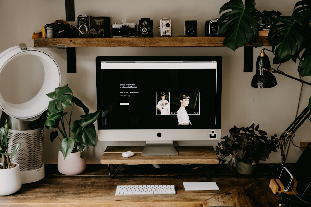 silver imac on brown wooden table