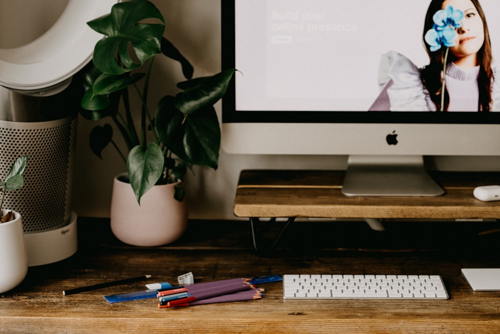 silver imac on brown wooden table