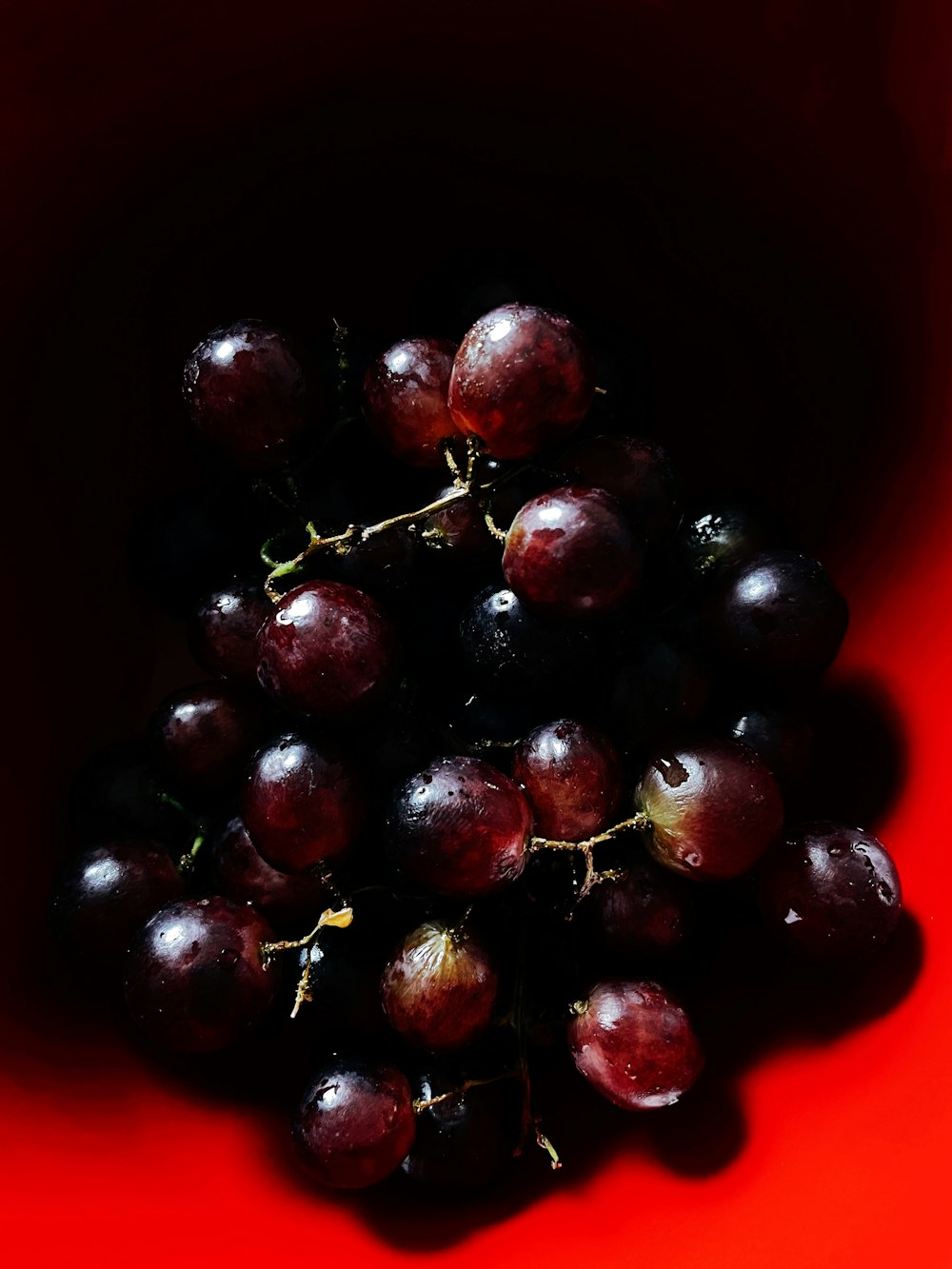 red round fruit on brown ceramic bowl