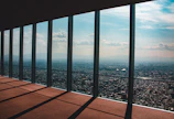 A panoramic elevator offering cityscape views inside a high-rise.