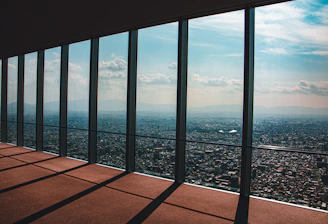 A panoramic view of a luxury penthouse overlooking a vibrant financial district at dusk, symbolizing success and stability.