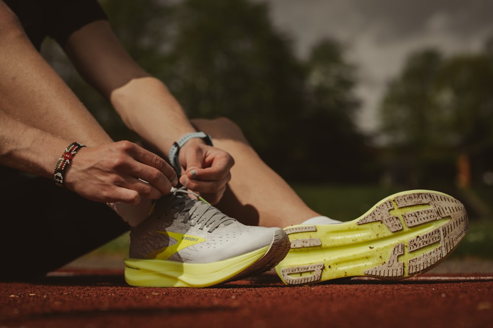 person wearing white and yellow sneakers