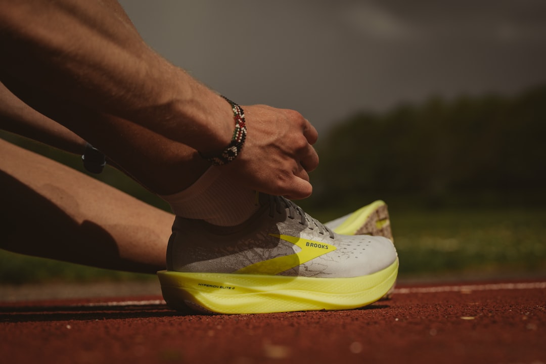 person wearing white and yellow nike sneakers