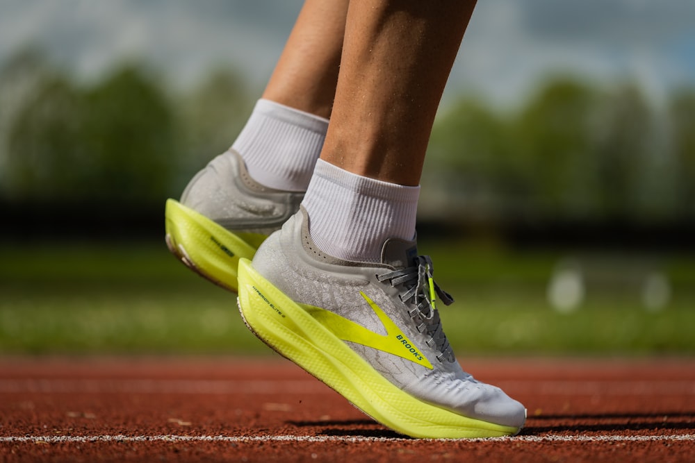 Person wearing yellow and white nike athletic shoes photo – Free Sneaker  Image on Unsplash