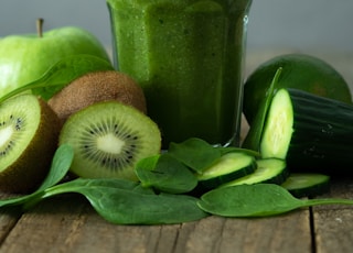 green liquid in clear drinking glass with straw