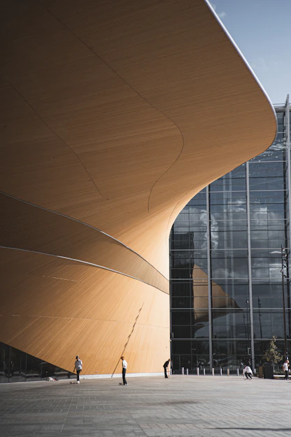 brown wooden round table near glass building