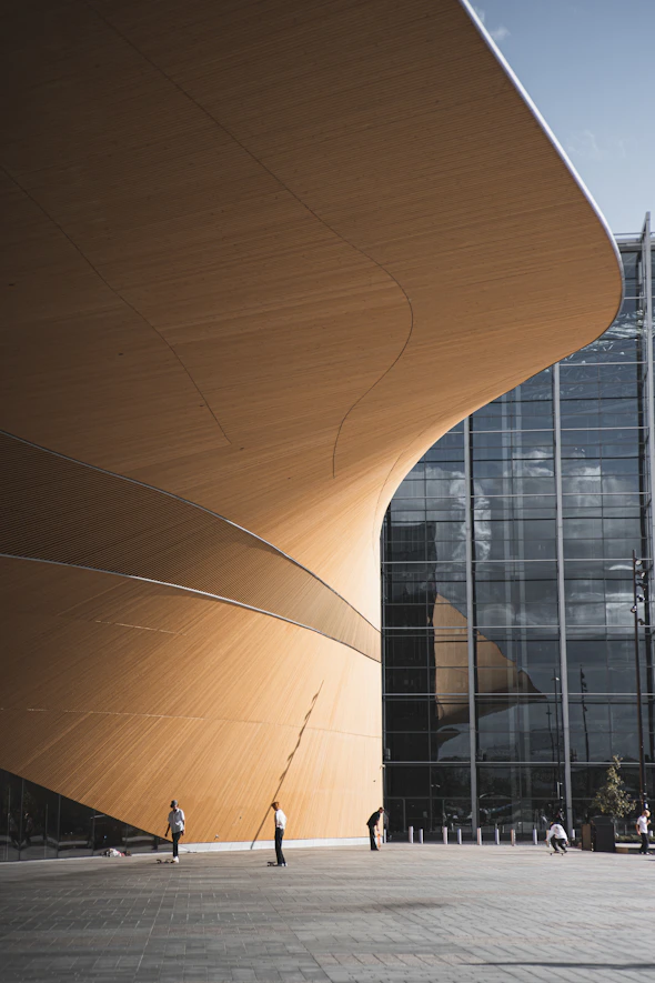 brown wooden round table near glass building