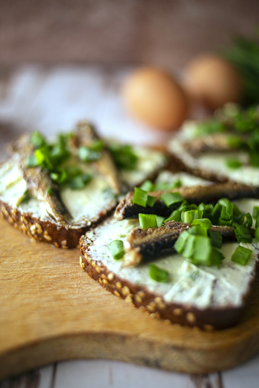 sliced bread with green vegetable on brown wooden table