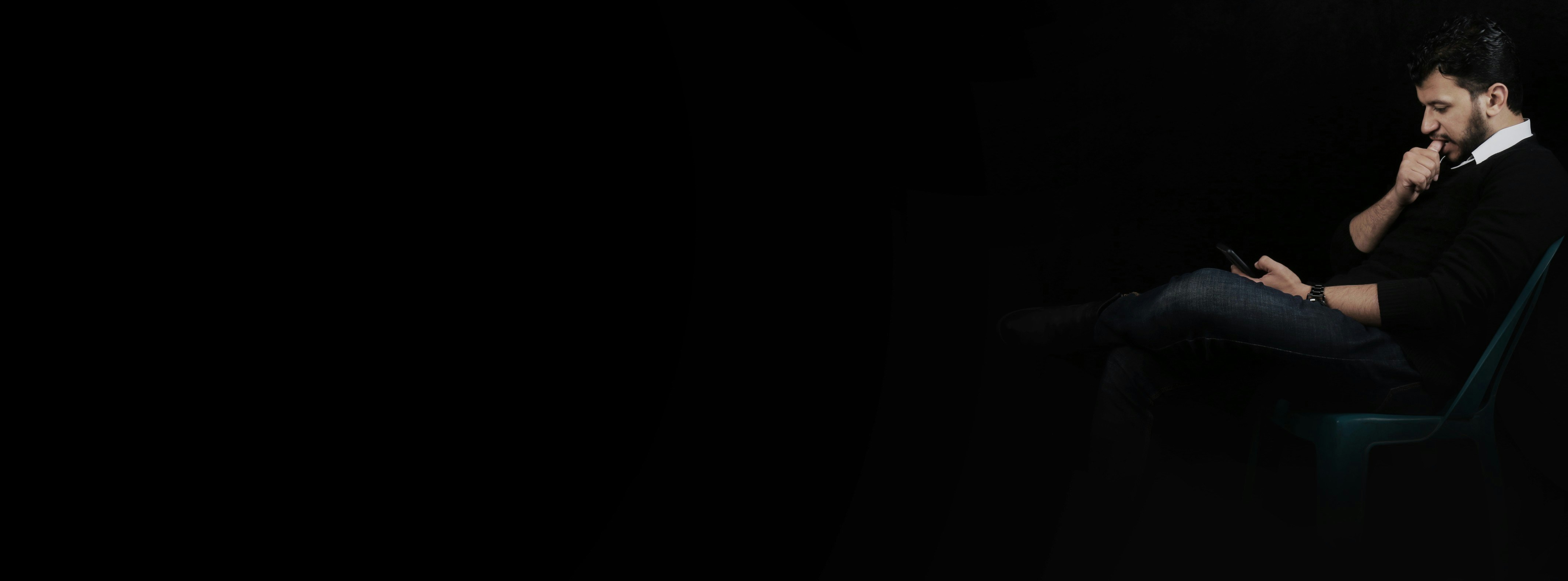 Man with his mobile in the dark