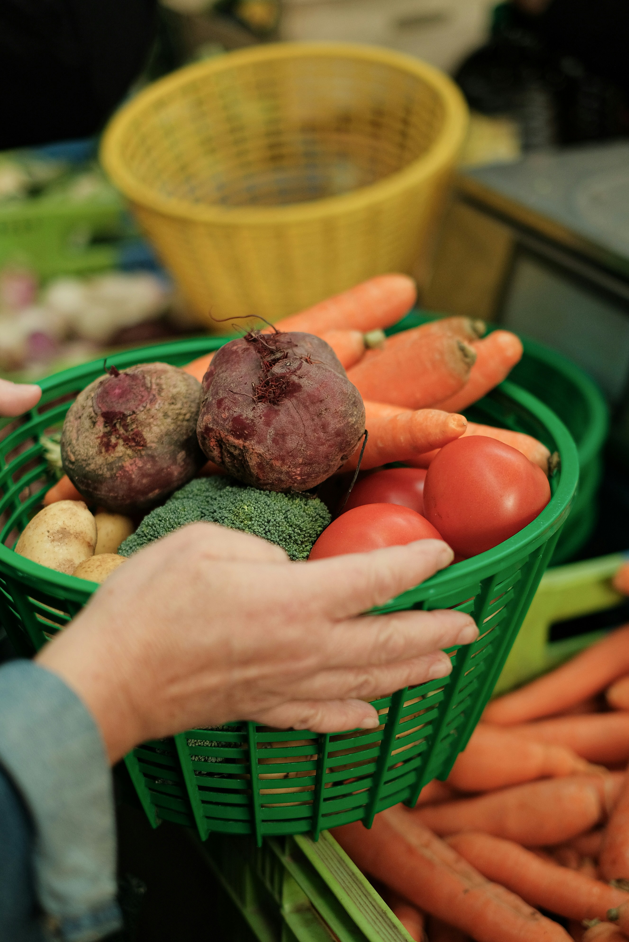 Fresh organic vegetables and fruits in a basket with bright natural lighting