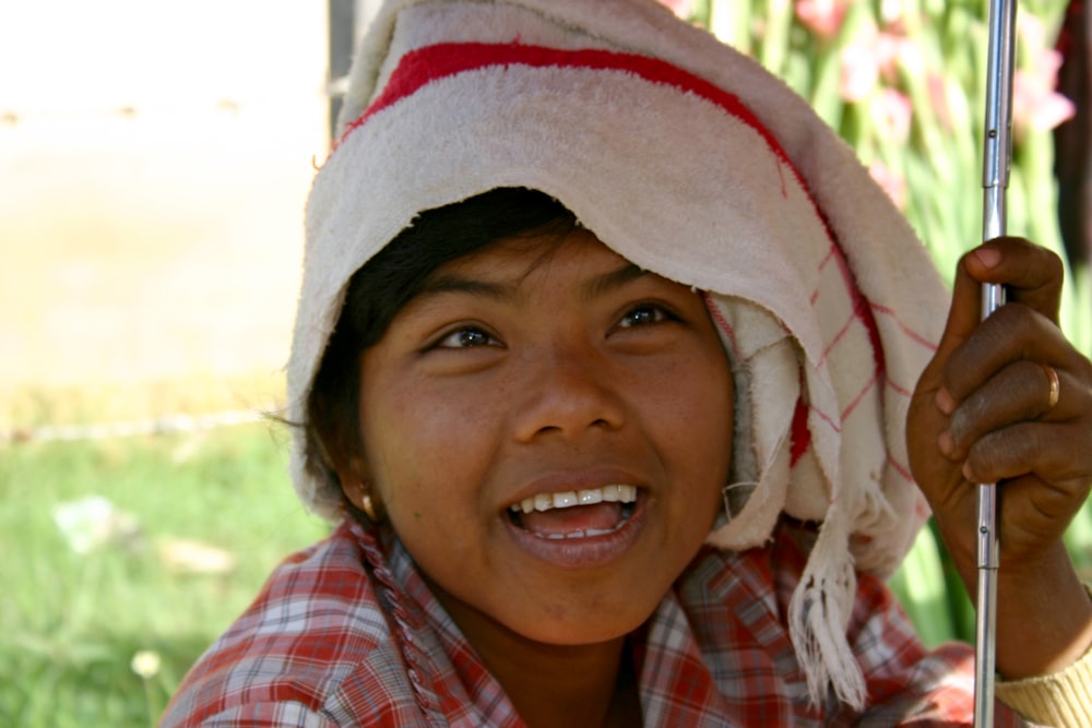 girl in red white and blue plaid shirt smiling