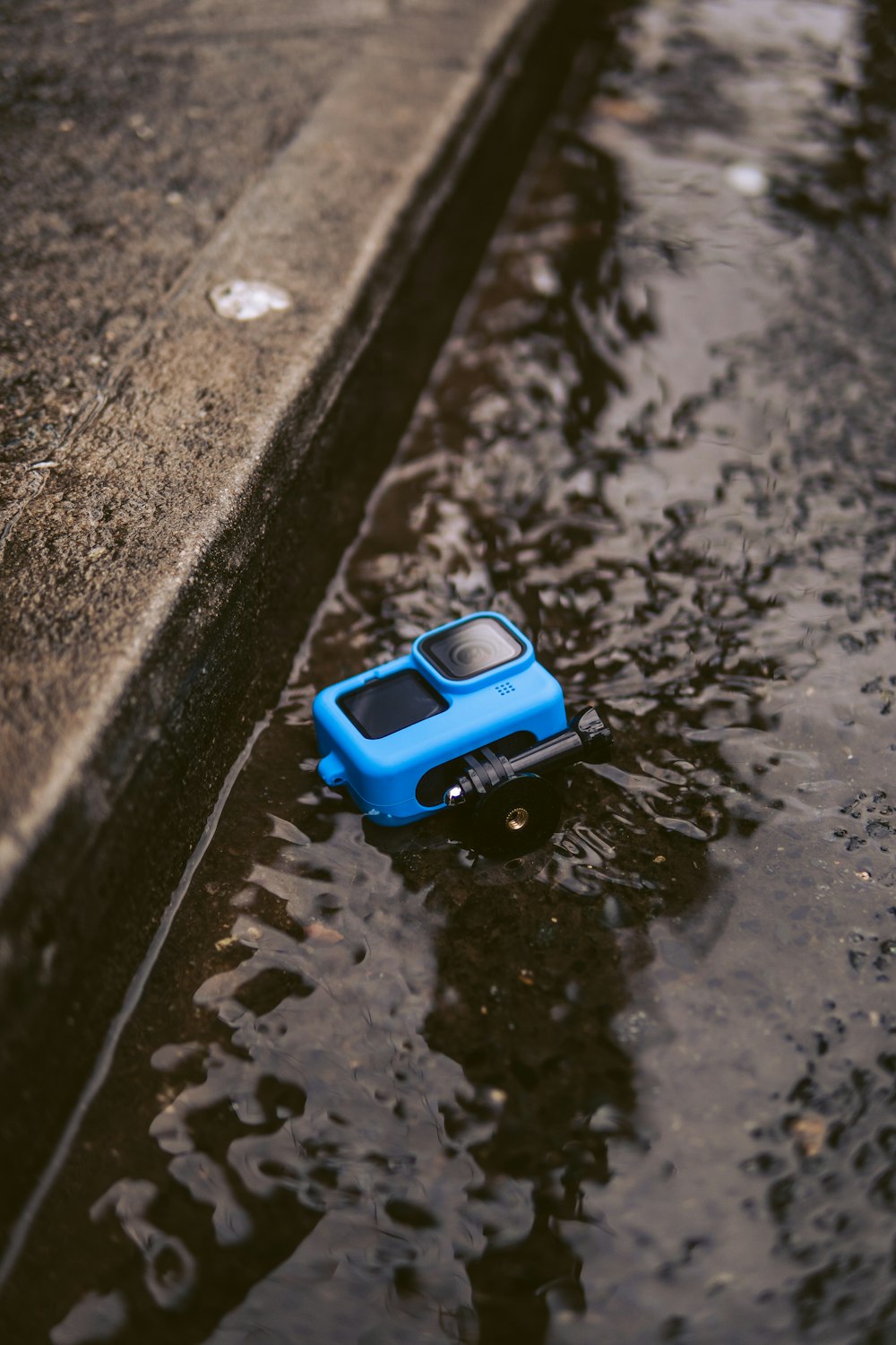 blue and black plastic toy car on water