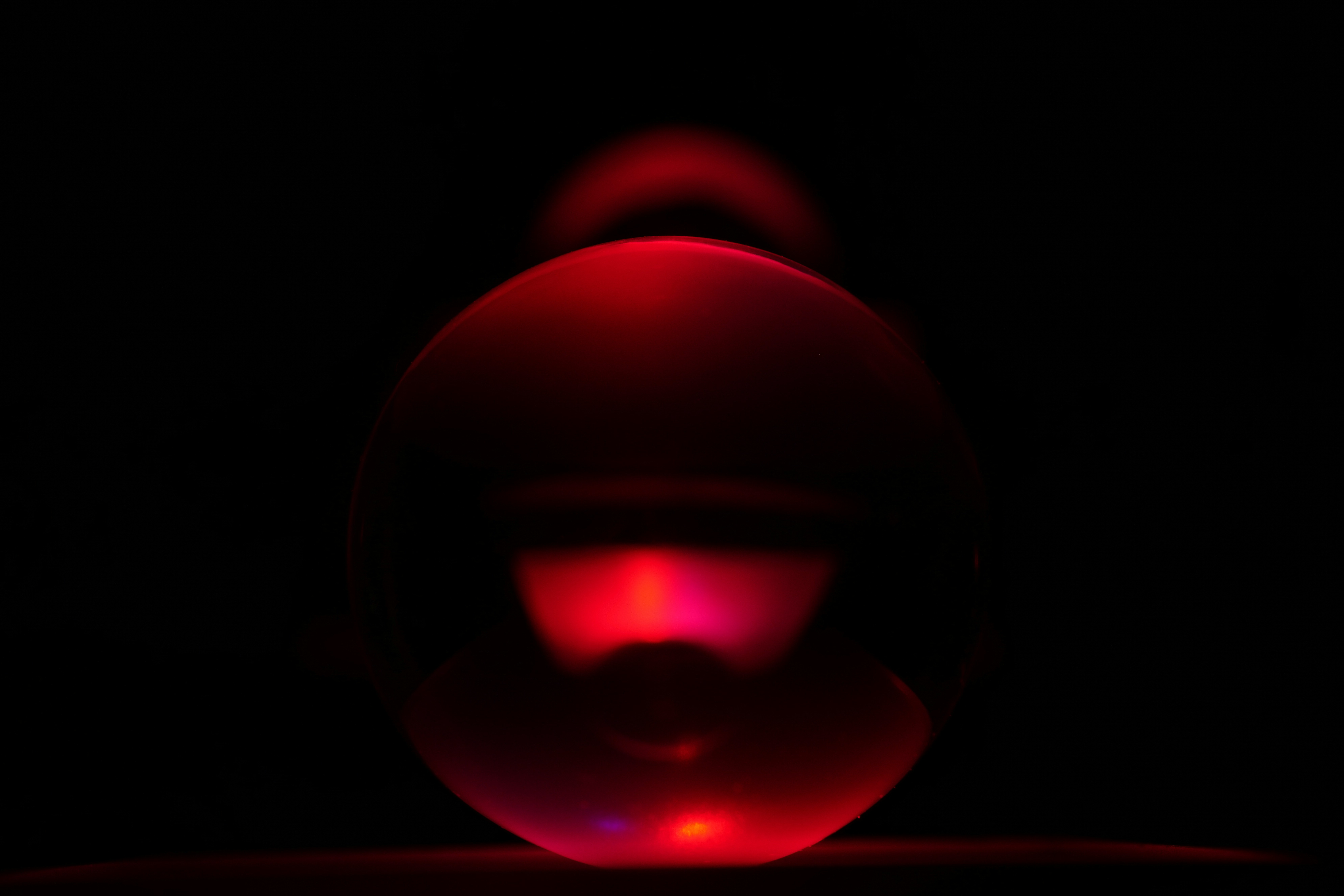 pink and black ball on brown wooden table