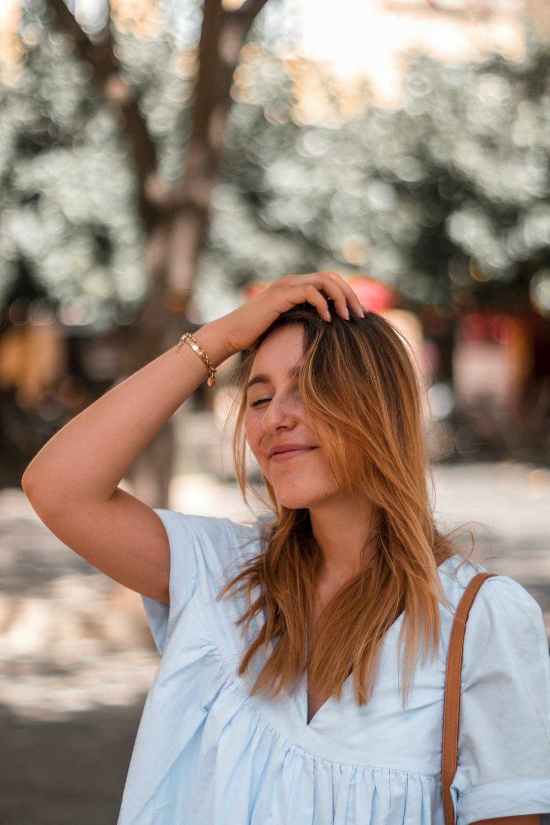 woman in white shirt covering her face with her hair