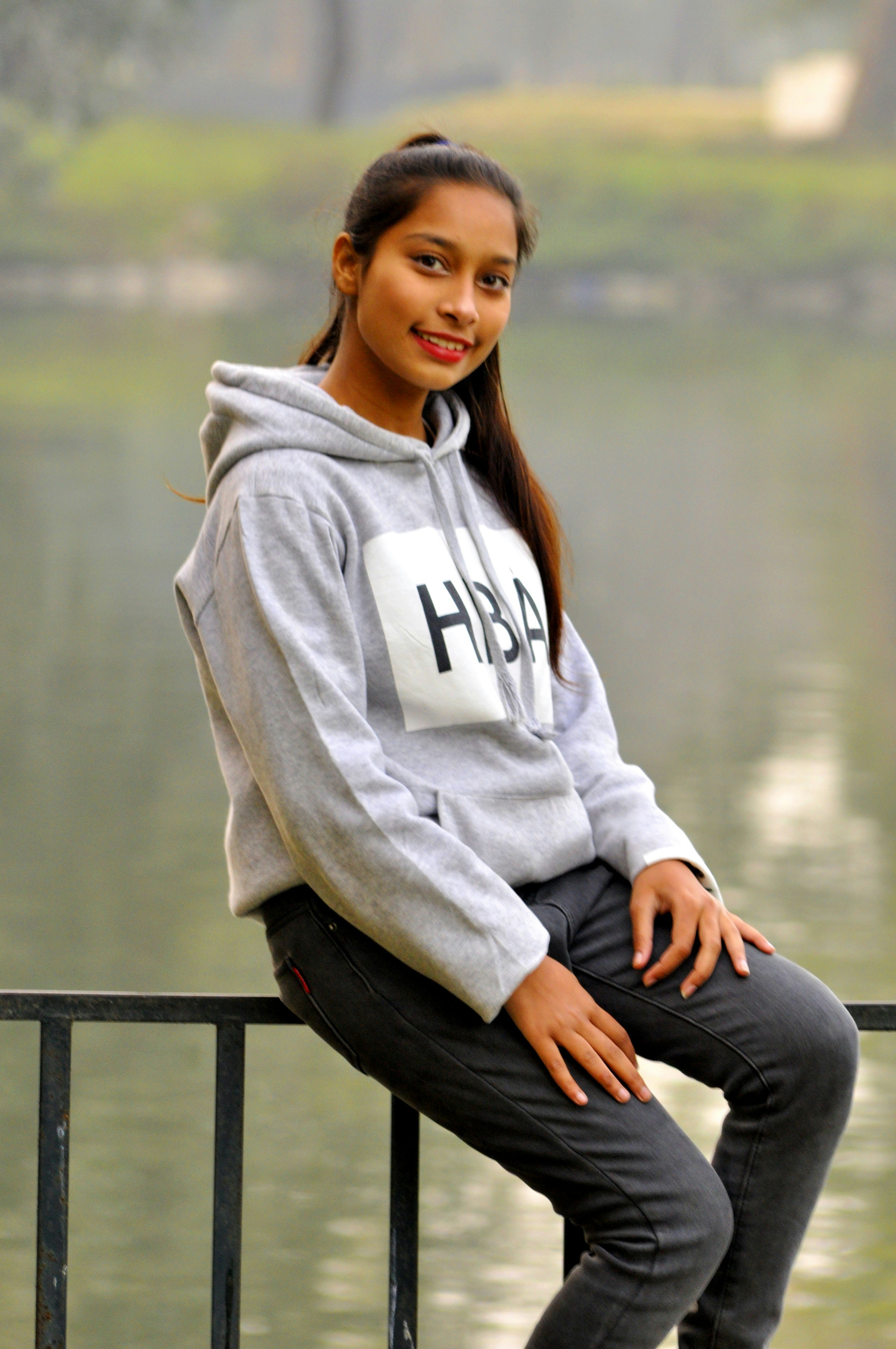 woman&nbsp;in&nbsp;gray&nbsp;hoodie&nbsp;sitting&nbsp;on&nbsp;black&nbsp;wooden&nbsp;bench