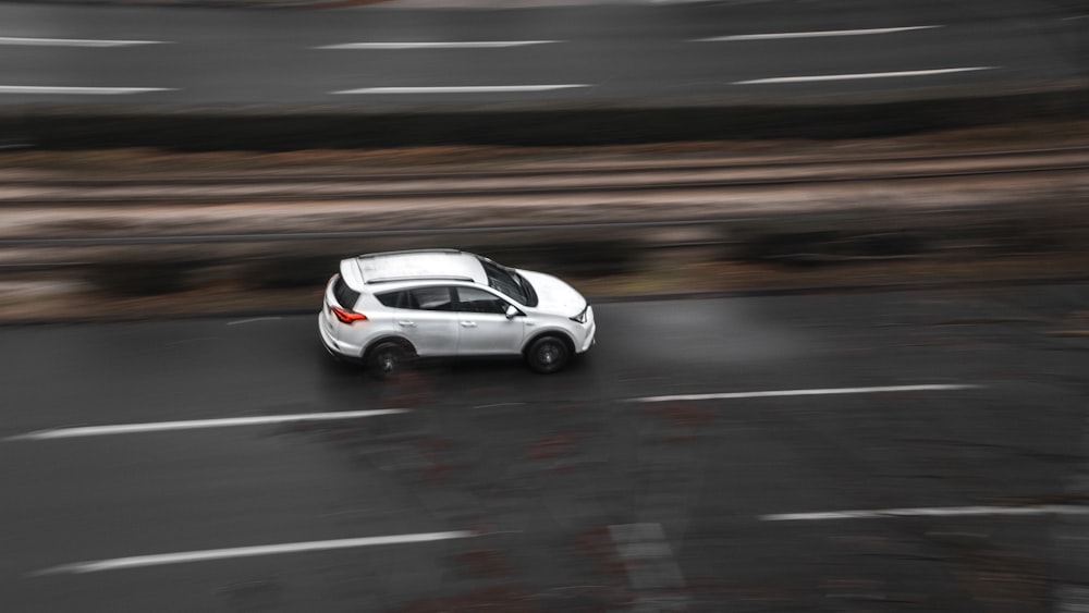 white sedan on road during daytime