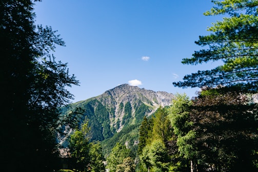 A picturesque mountain landscape with a clear blue sky.