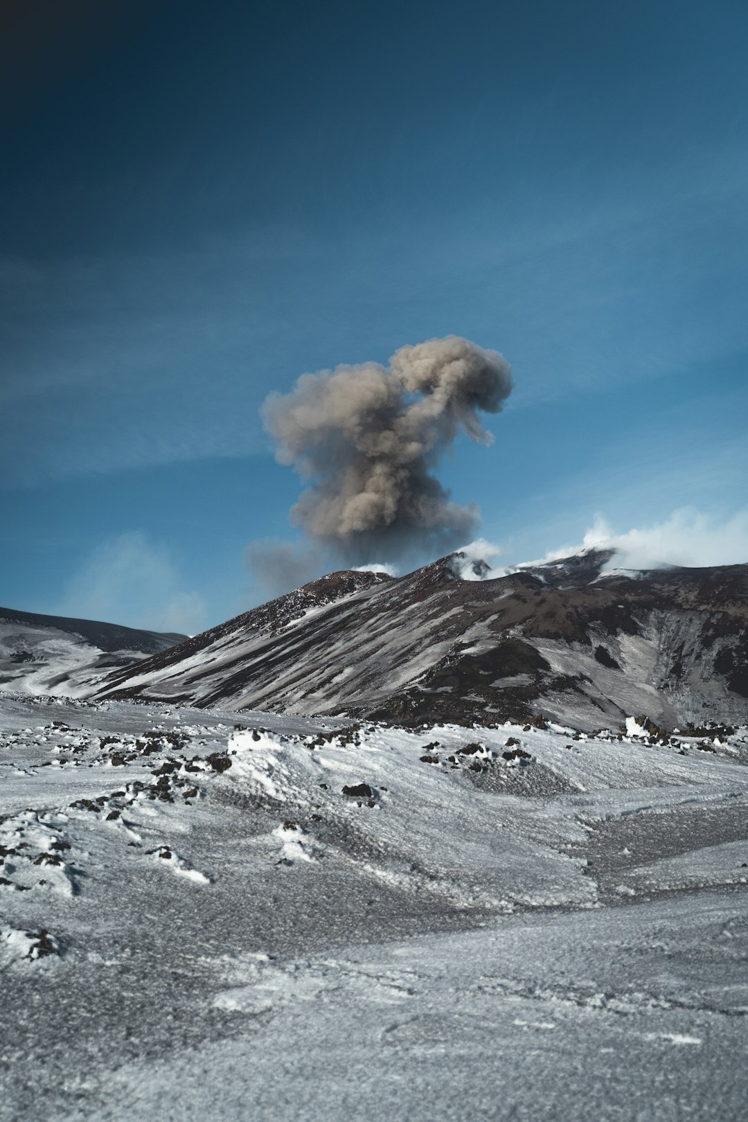 white clouds over snow covered mountain