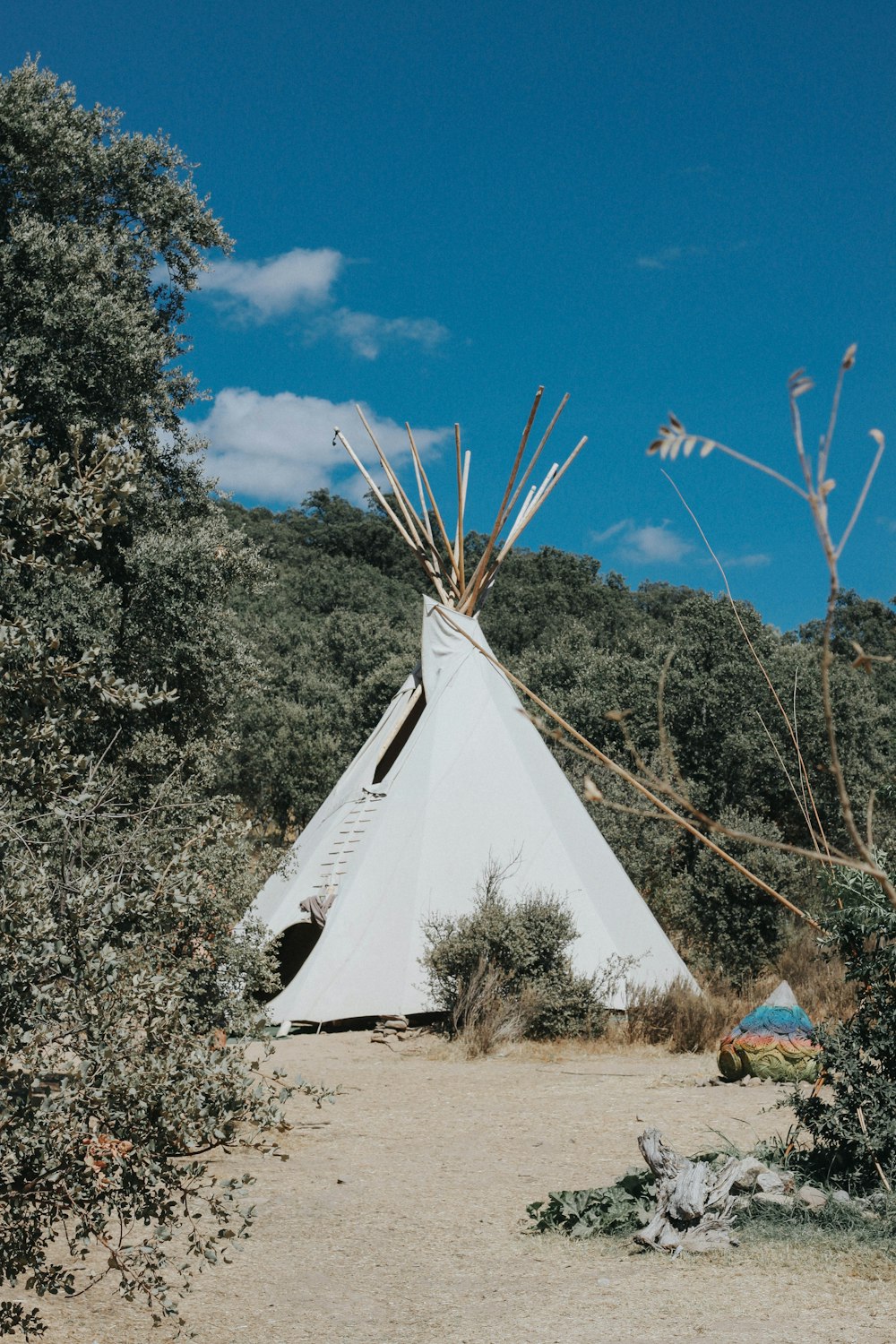 white tent on brown field under blue sky during daytime