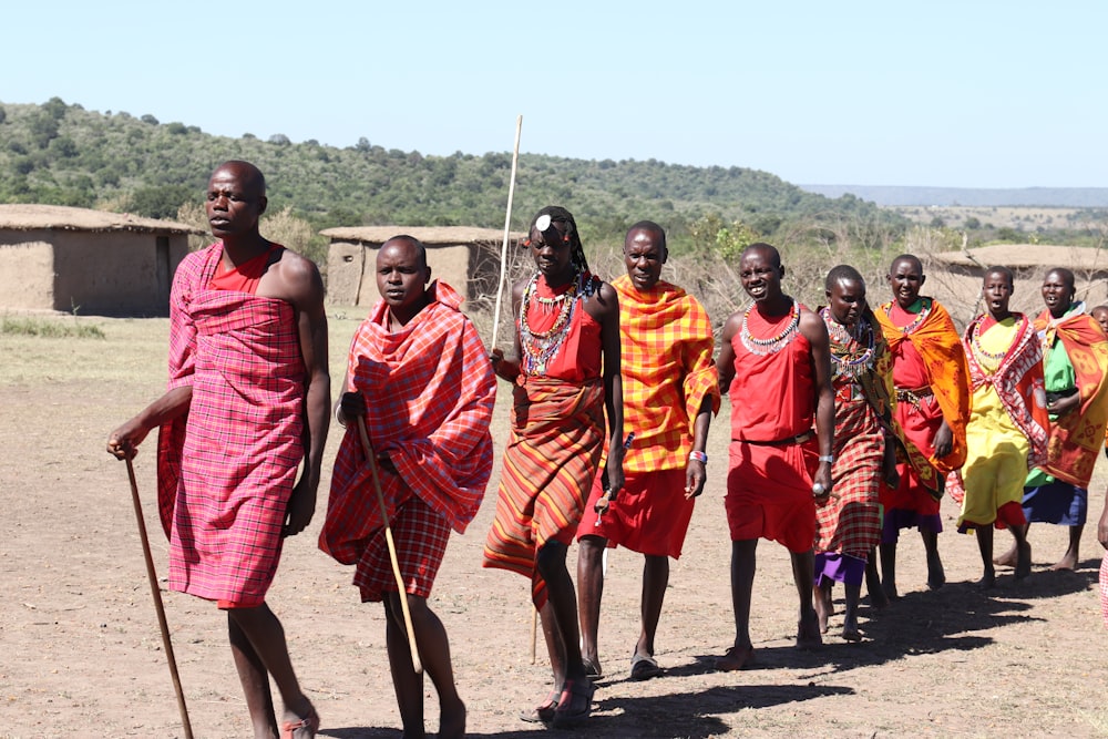 group of people wearing orange and yellow traditional dress