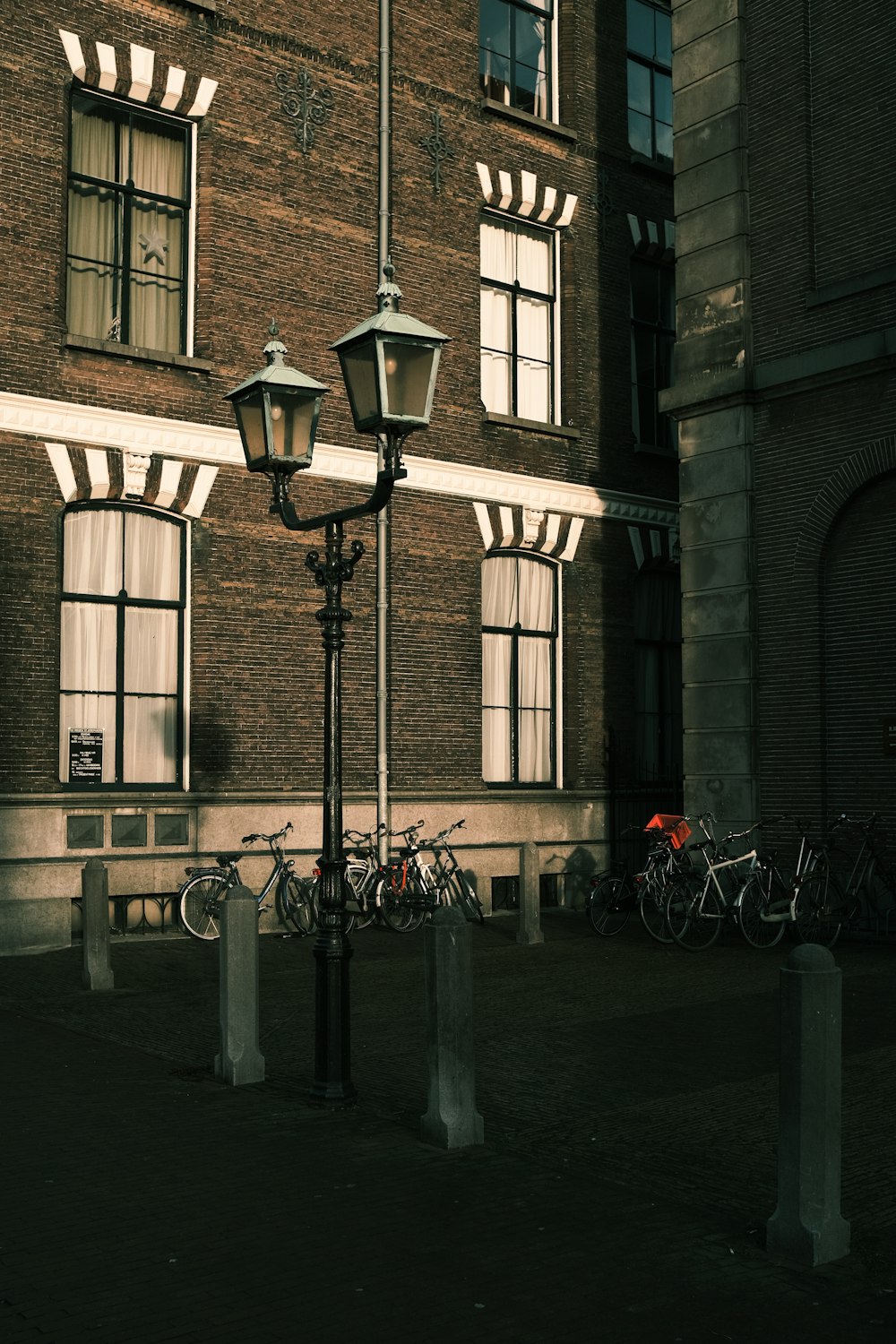 black street light near brown concrete building during daytime