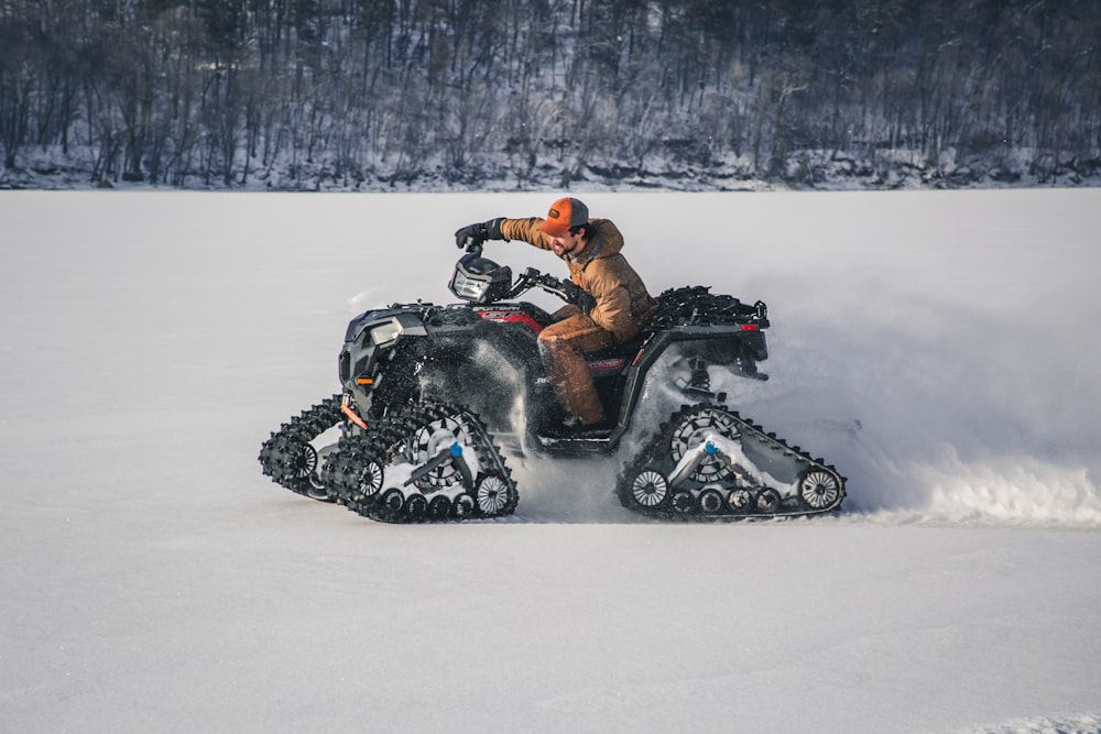 black and red snow mobile on snow covered ground