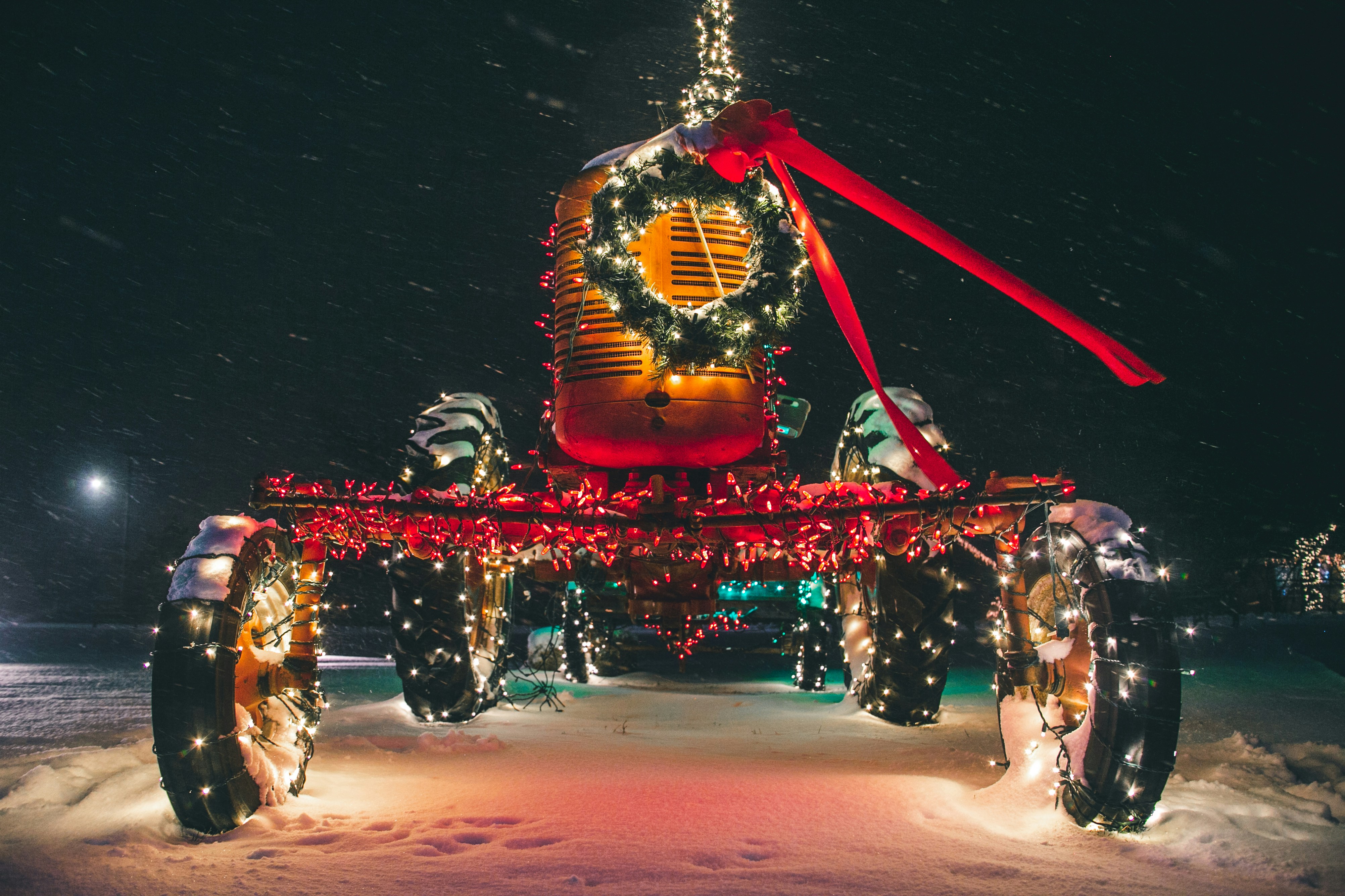 a horse drawn carriage covered in christmas lights
