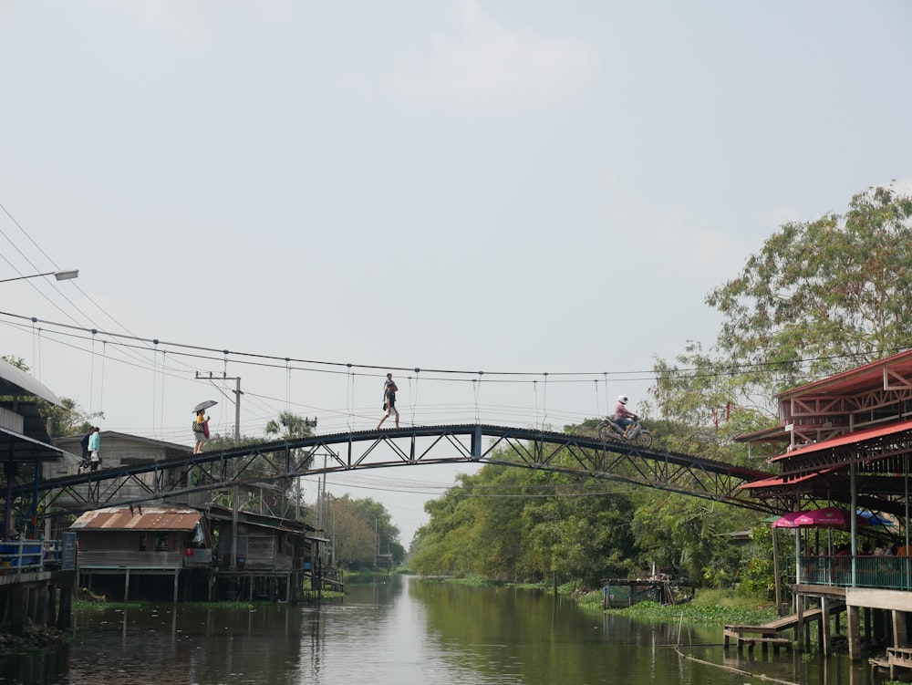 bridge over river under white sky