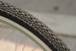 A bicycle tire with visible rubber tread on a sunny street