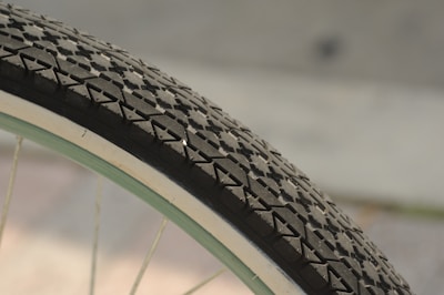 A bicycle tire with visible rubber tread on a sunny street