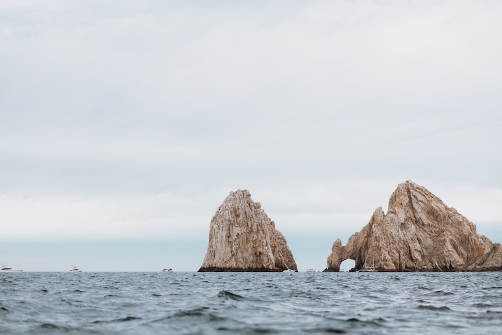 brown rock formation on sea during daytime