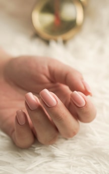 manicured hands on white fur