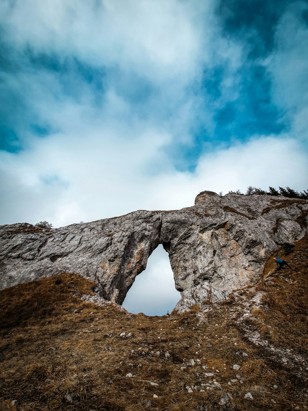 gray rock formation under blue sky and white clouds during daytime