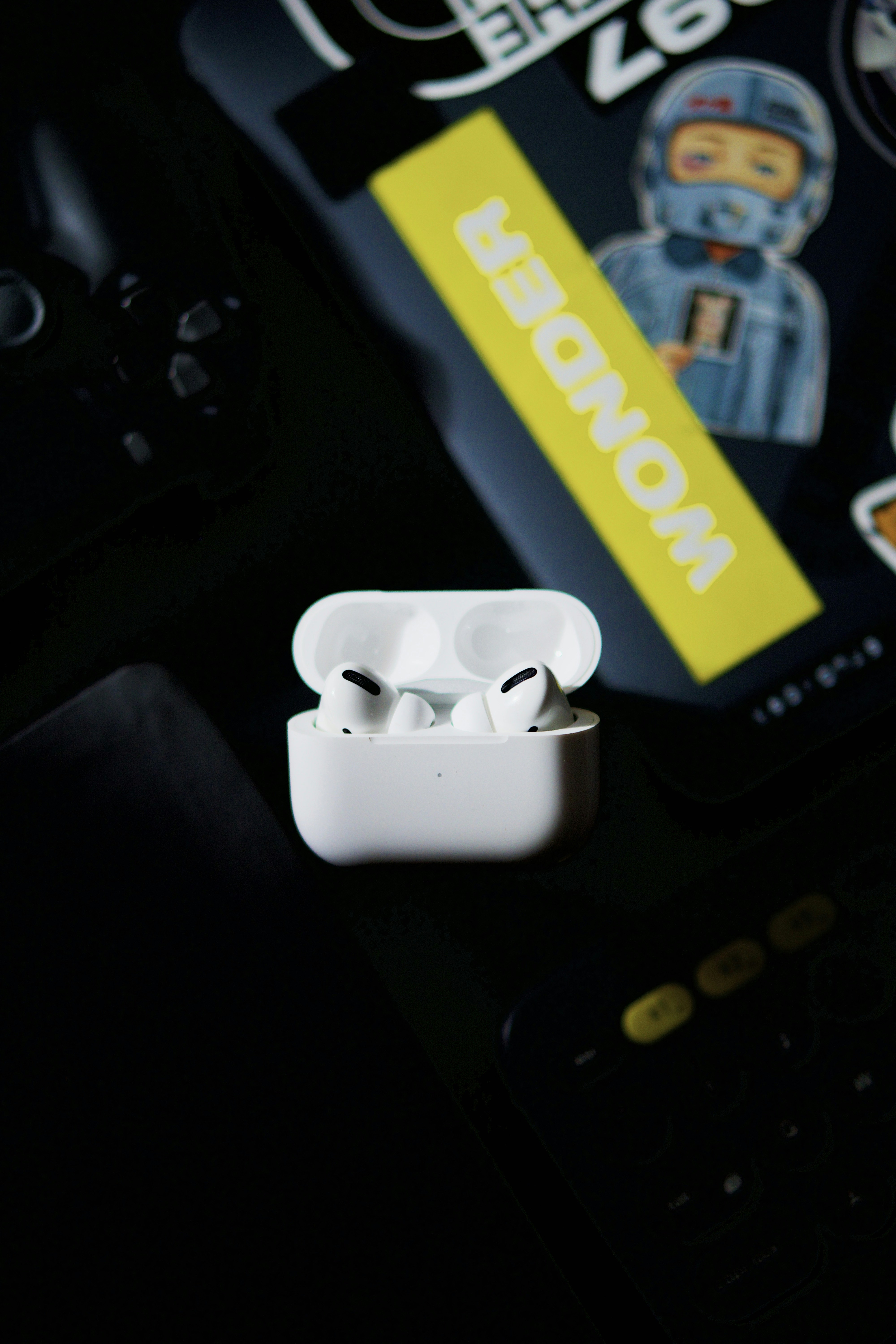 True wireless earbuds in open case, dark background, clean studio lighting, minimal aesthetic